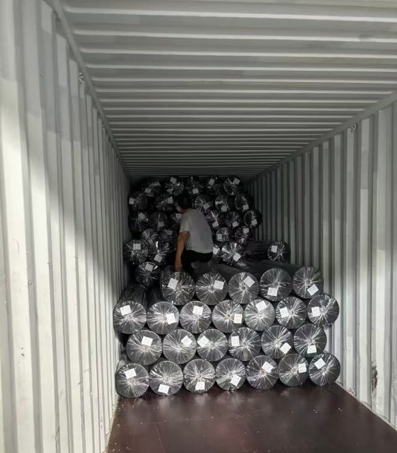 Fabric rolls loaded into a container